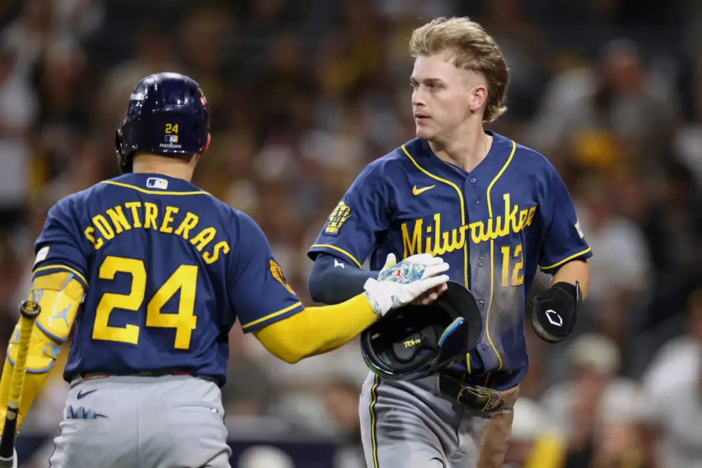 The Milwaukee Brewers’ Cooper Pratt (12) is congratulated by teammate...