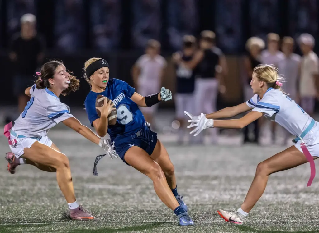 Newport Harbor quarterback Scarlett Guyser (9) carries the ball on...