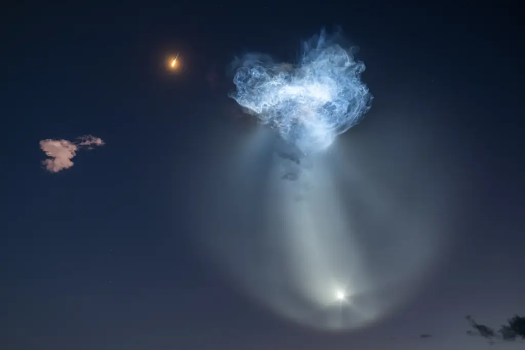 The exhaust plumes of a SpaceX Falcon 9 rocket carrying...