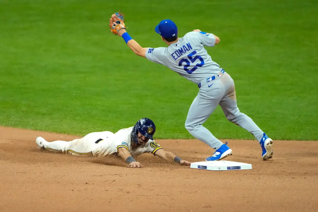 The Milwaukee Brewers’ David Hamilton, left, steals second base as...