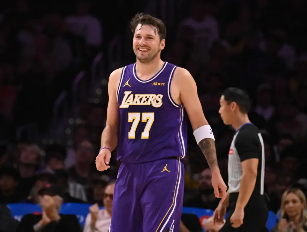 Lakers star Luka Doncic smiles after scoring during the first...