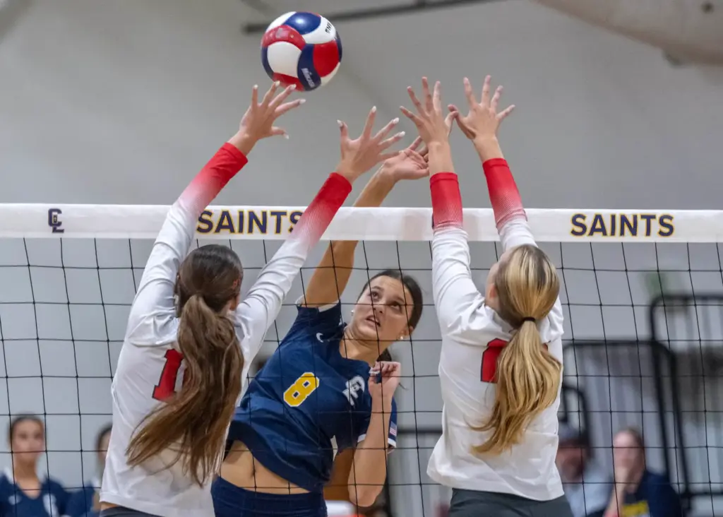 Crean Lutheran middle blocker Liberty Badorek (8) hits the ball...