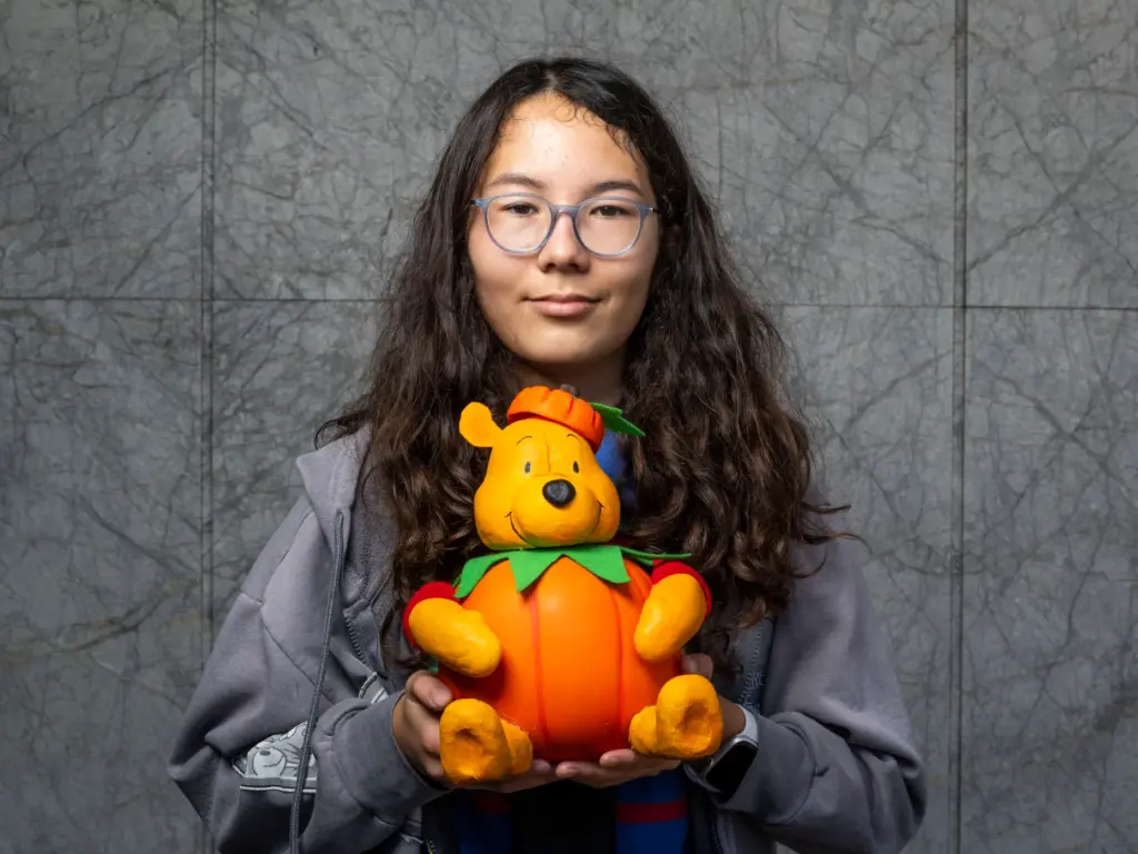 Hazel Carlson holds her pumpkin titled âPumpkin Poohâ which she...