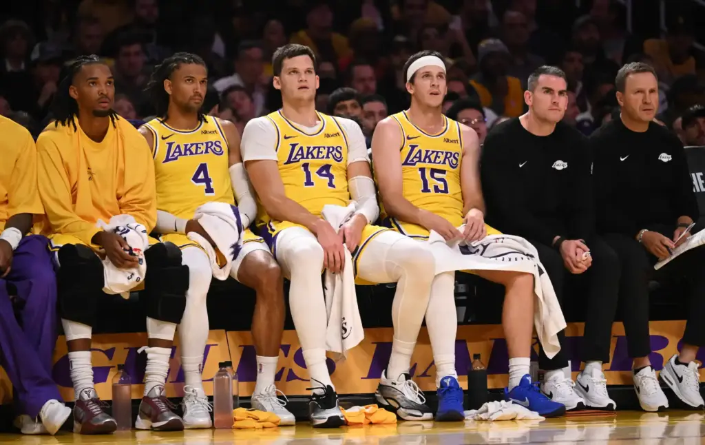 Lakers guard Austin Reaves (15) watches from the bench with...
