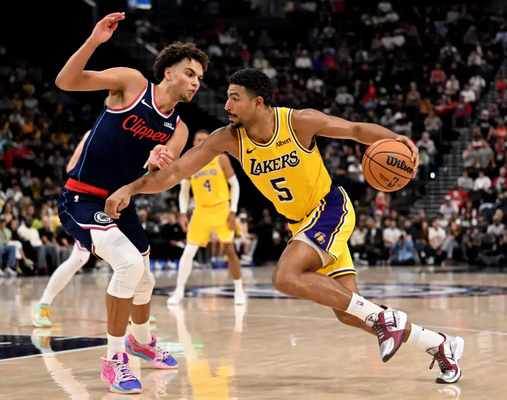 Lakers guard Quentin Grimes drives to the basket as Clippers...