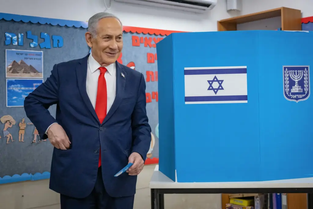Israel's Prime Minister Benjamin Netanyahu reacts after filling out his ballot.