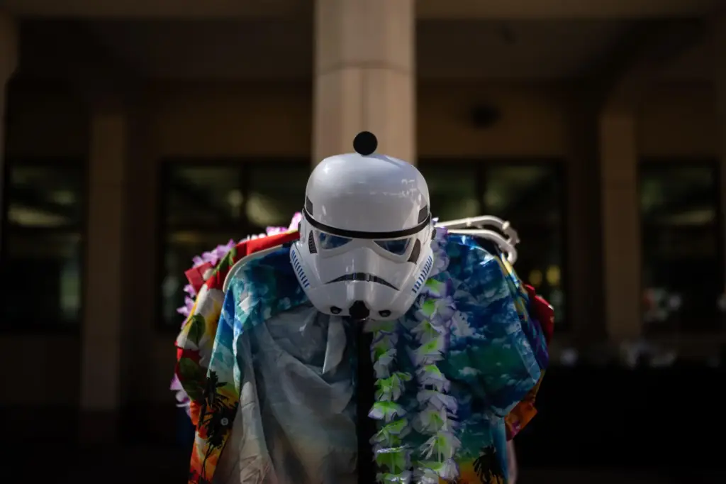 A stormtrooper mask is displayed with Hawaiian shirts and leis...