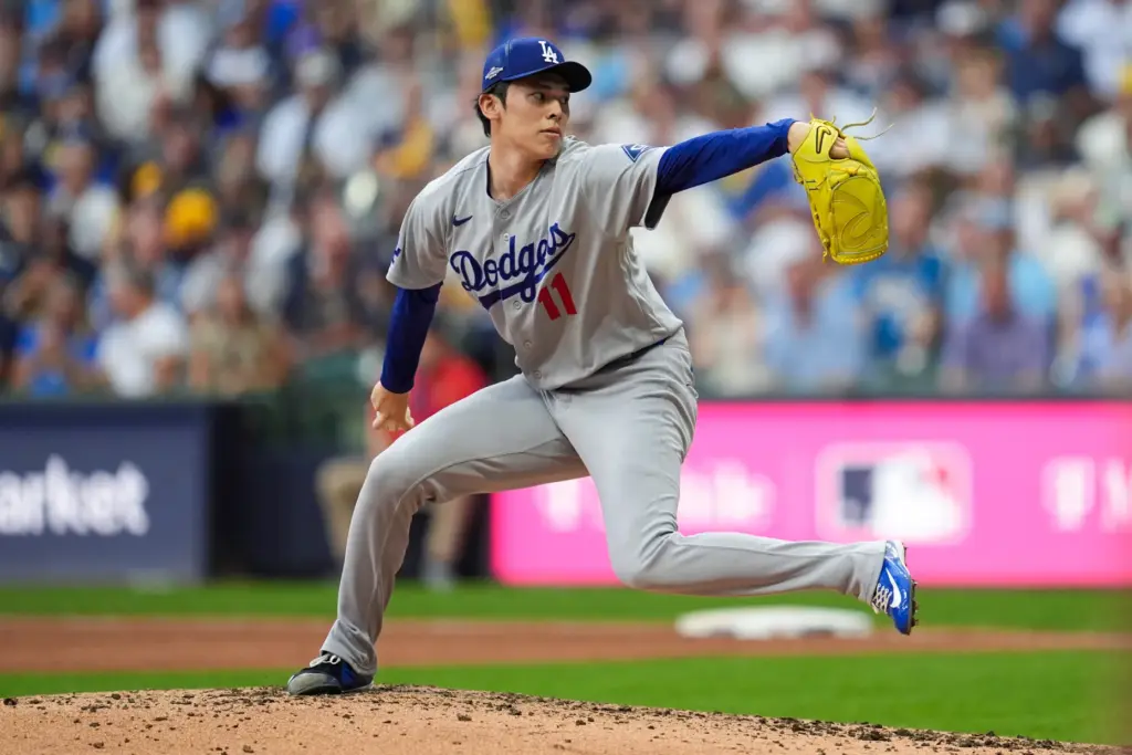 Dodgers relief pitcher Roki Sasaki throws to the plate during...