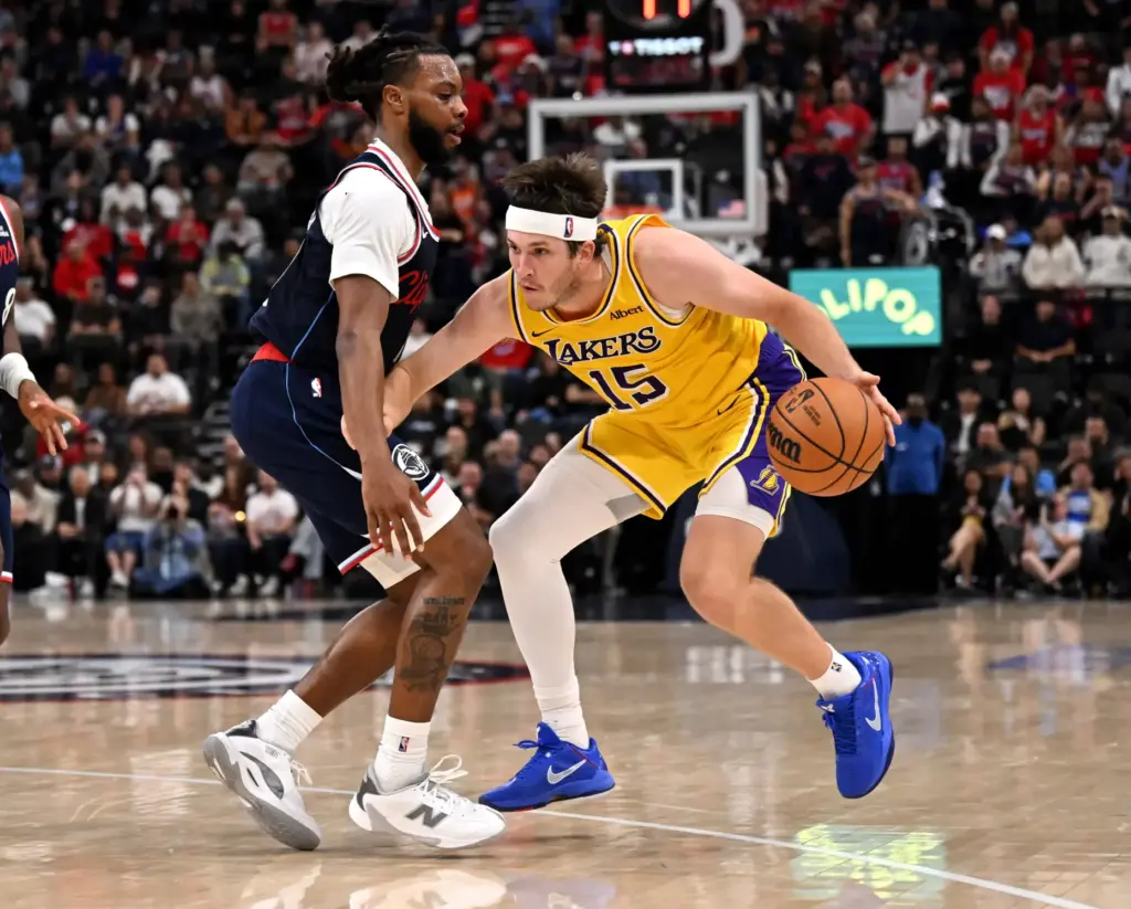 Lakers guard Austin Reaves handles the ball as Clippers point...