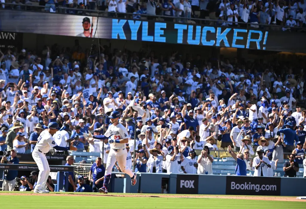 The Dodgers’ Kyle Tucker, right, is congratulated by third base...