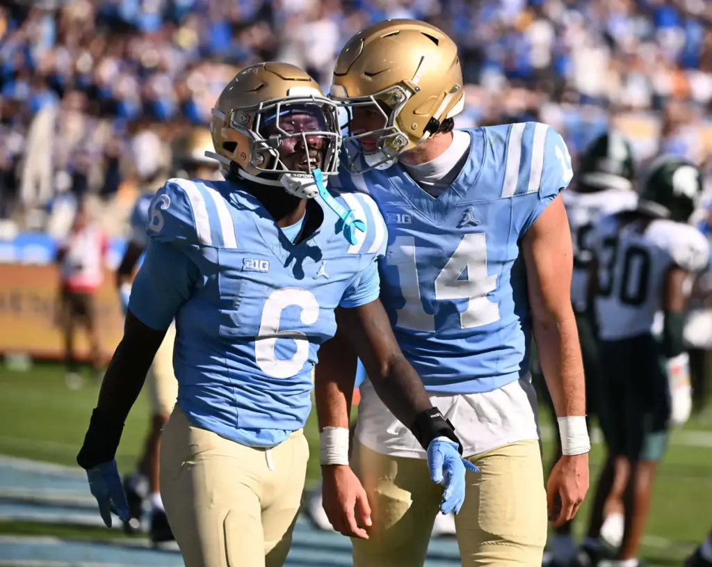 UCLA running back Anthony Woods (6) celebrates with quarterback Ty...