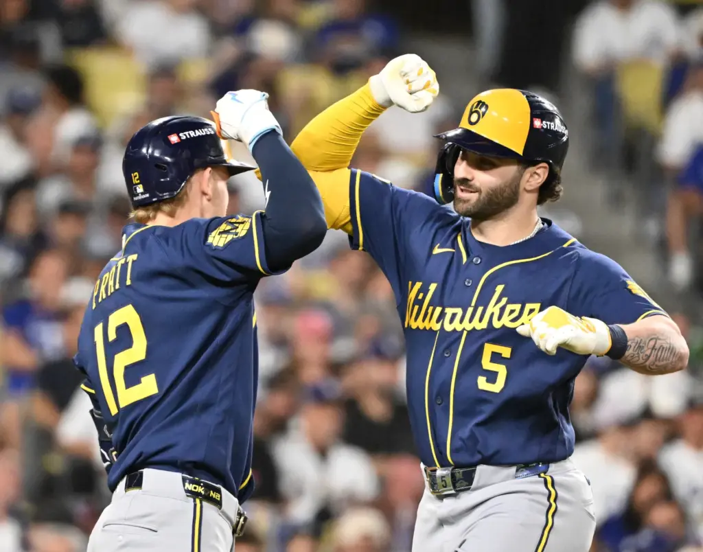 The Milwaukee Brewers’ Garrett Mitchell, right, celebrates with teammate Cooper...