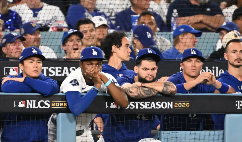 Dodgers players look on from the dugout during the eighth...