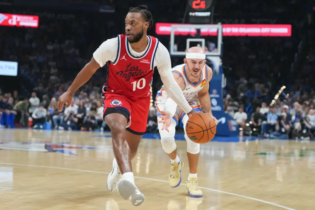 Oklahoma City Thunder guard Alex Caruso, right, steals the ball...