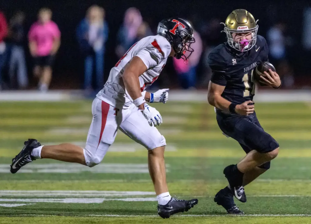 San Juan Hills quarterback Parker Armstrong (18) carries the ball...