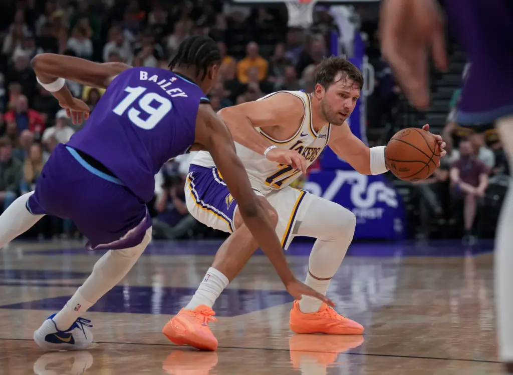 Lakers forward/guard Luka DonÄiÄ (77) avoids a block from Utah...