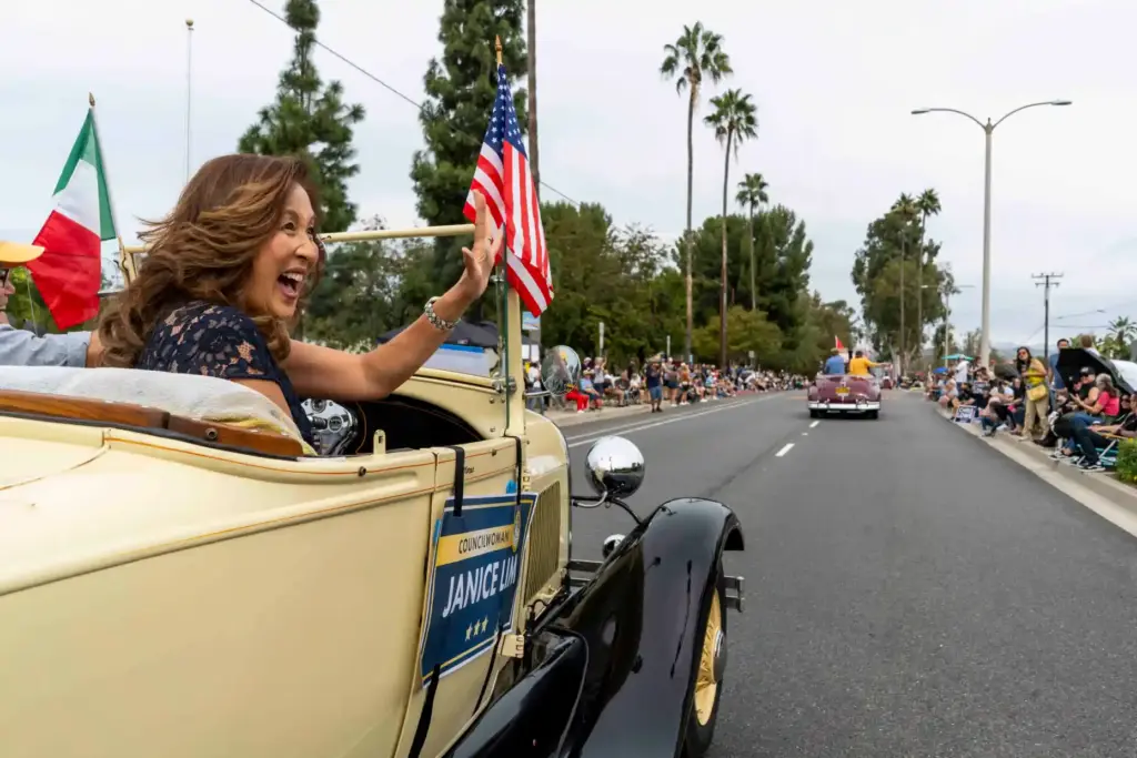 Janice Lim, council member of Yorba Linda, waves to spectators...