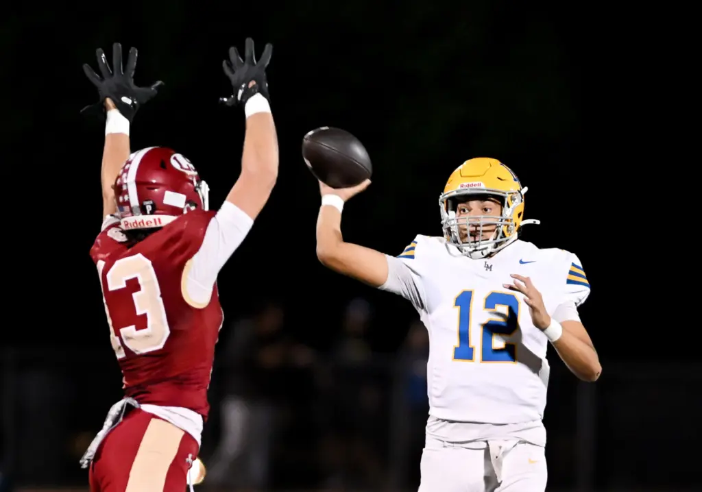 La Mirada Matadores quarterback Isaac Cuevas (12) passes under pressure...