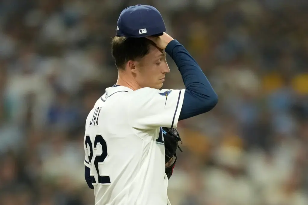 Tampa Bay Rays starting pitcher Griffin Jax reacts after walking...
