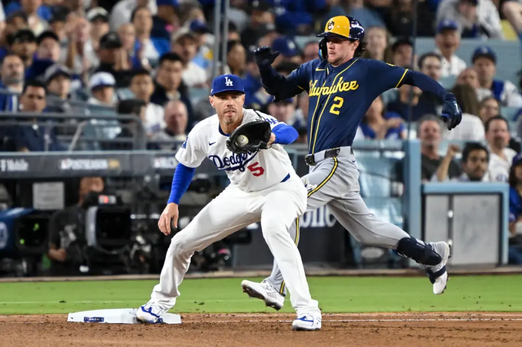 The Milwaukee Brewers’ Brice Turang, right, is thrown out on...
