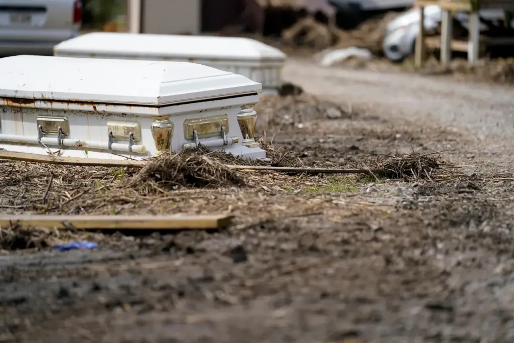 FILE – Caskets, that floated from their tombs during flooding...