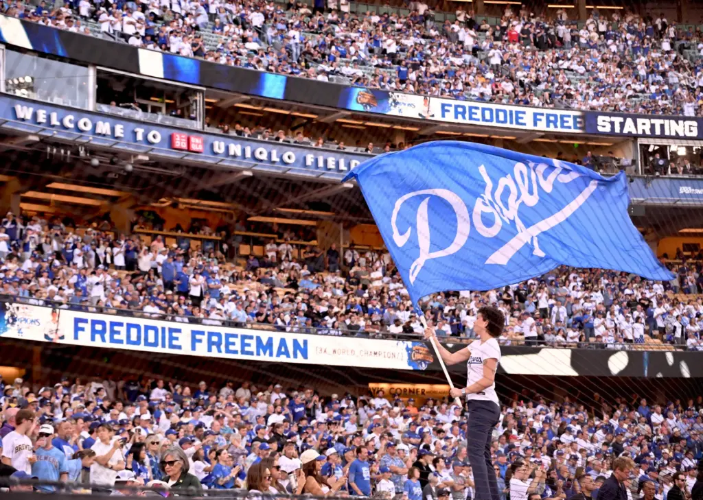 A member of the Dodgers Blue Crew waves a flag...