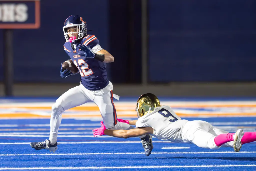 Chaminade High Schoolâs Andrew Cordero (12) attempts to elude a...