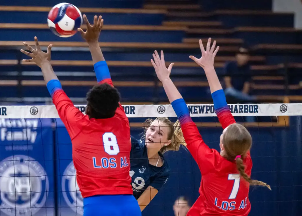 Newport Harbor outside hitter Piper Coady (19) hits the ball...