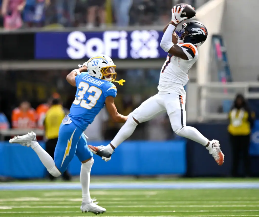 Denver wide receiver Jaylen Waddle hauls in a pass as...