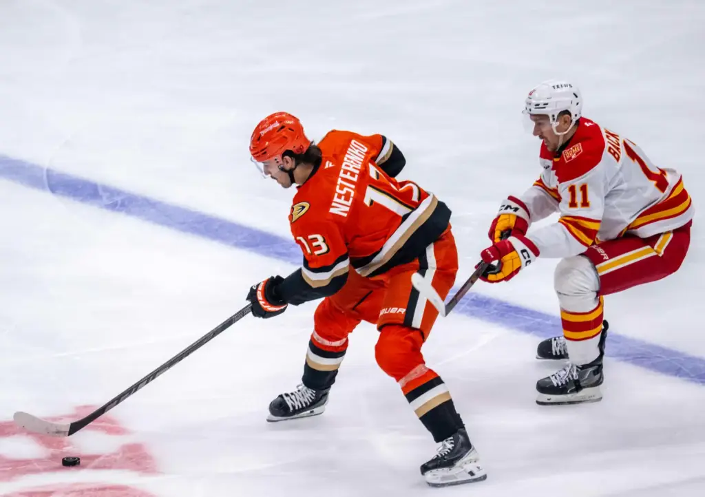 The Ducksâ Nikita Nesterenko, left, brings the puck up the...