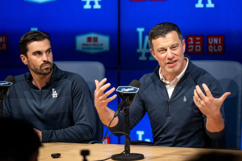 Dodgers president of baseball operations Andrew Friedman, right, speaks to...