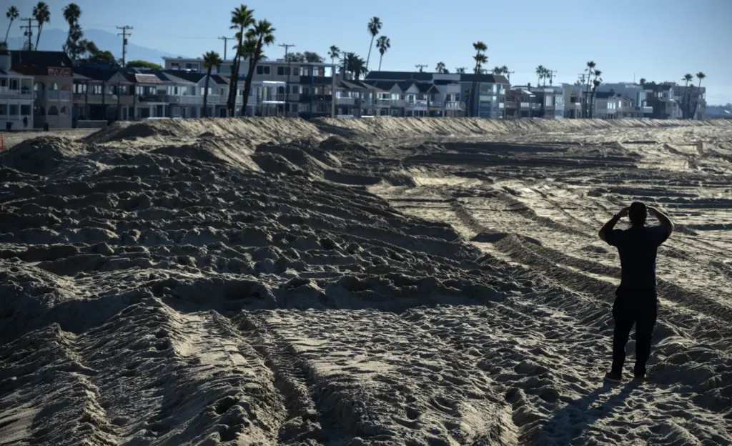 Sand berms are in place near homes in Seal Beach...
