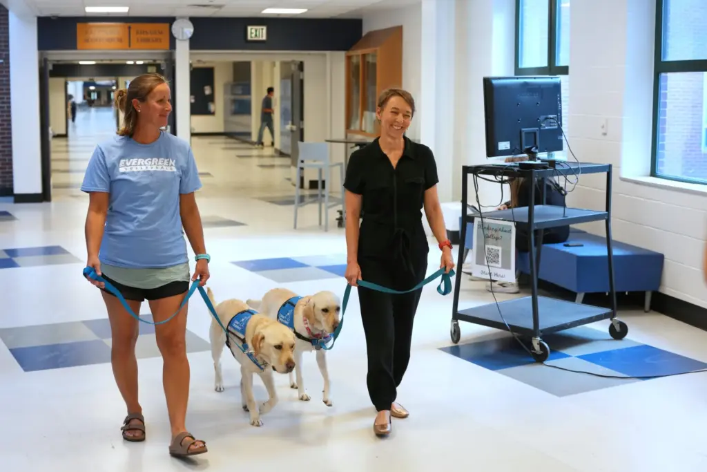 Amy Wells, left, counselor at Evergreen High School, walks with...