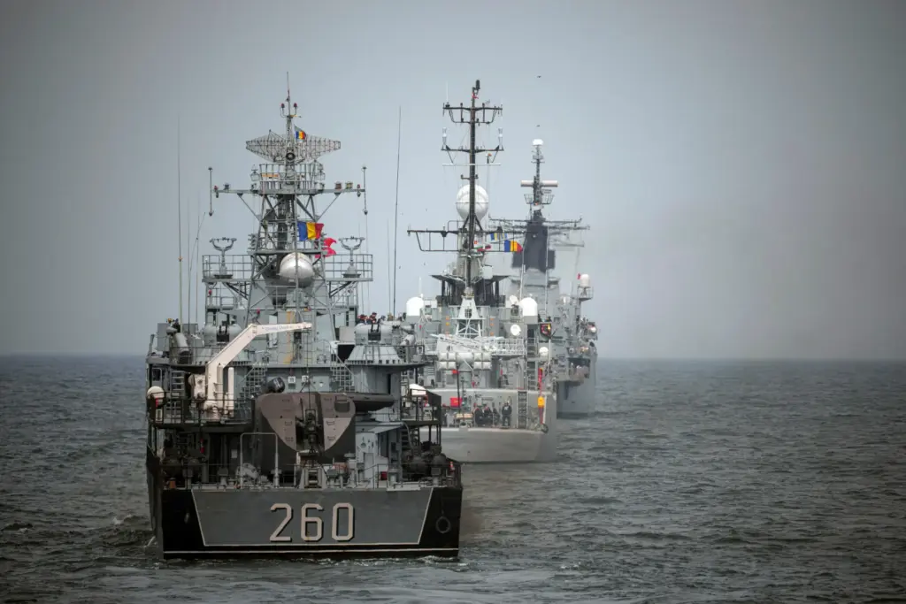FILE – Romanian warships sail during a Romanian Navy led...