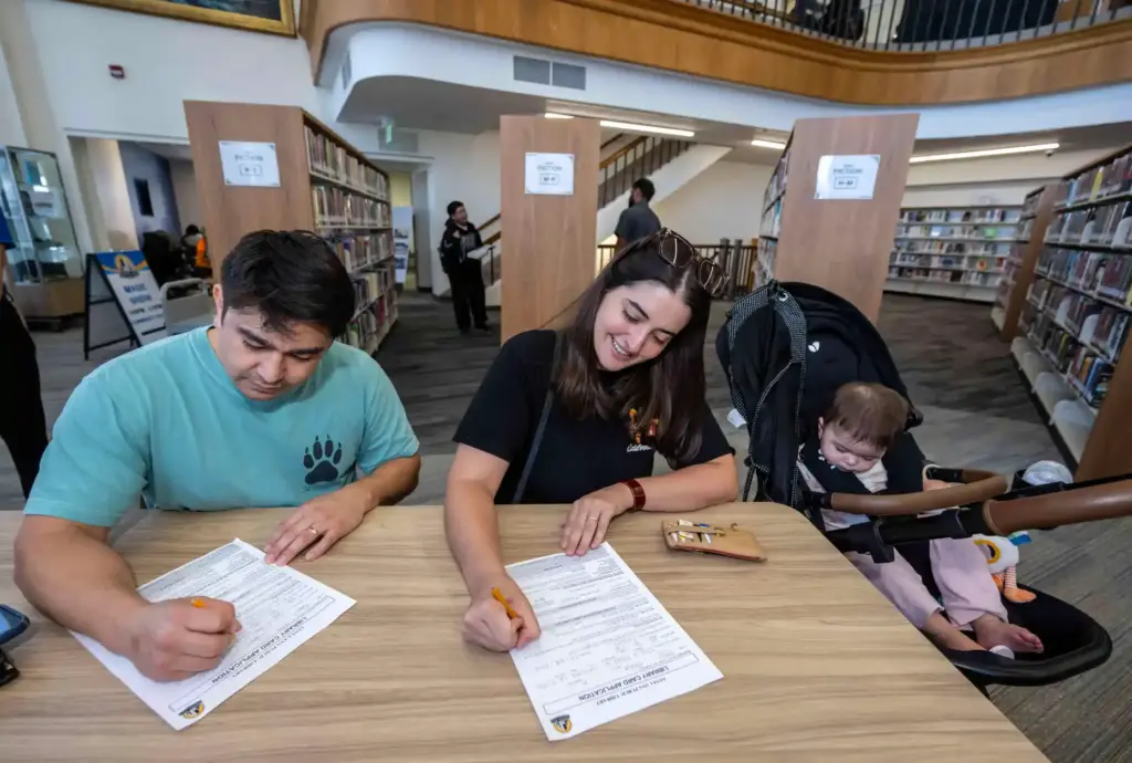 Santa Ana residents Daniel Garcia and Karina Martin fill out...