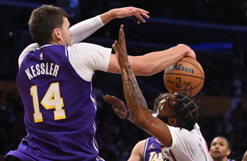 Lakers center Walker Kessler, left, blocks a shot by Clippers...