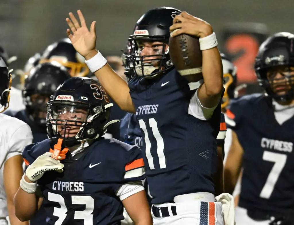 Justin Hall #11 of Cypress celebrates after scoring a TD...