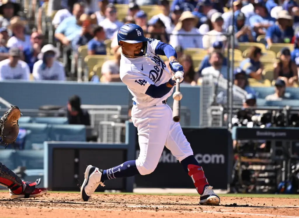 The Dodgers’ Mookie Betts hits a bloop single during the...