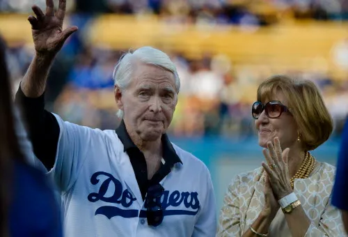 Former Los Angeles Dodgers General Manager Fred Claire waves to...