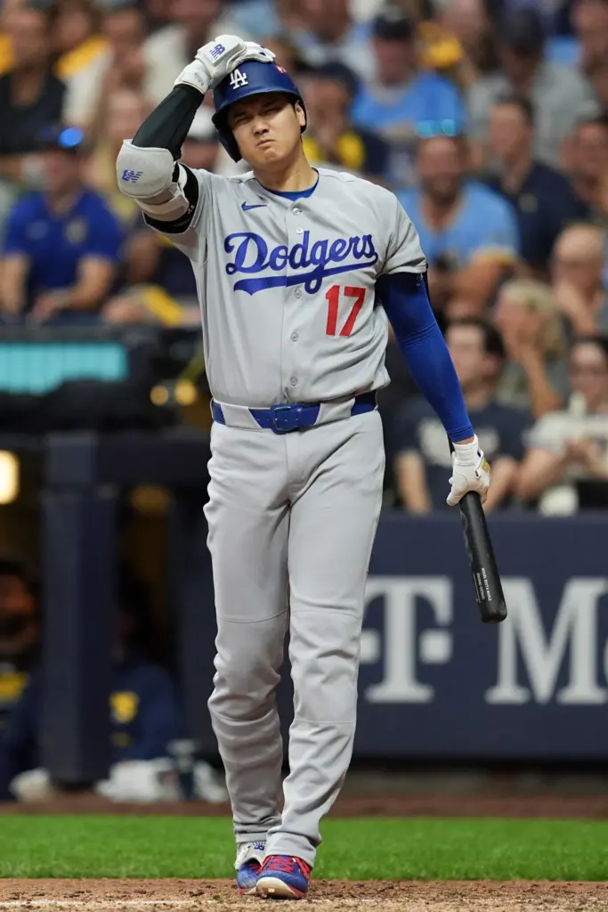 Dodgers star Shohei Ohtani reacts to a strike while batting...