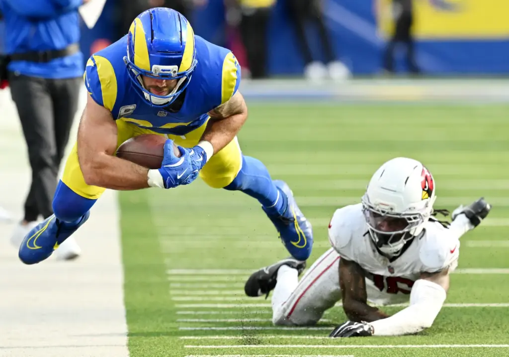 Rams tight end Colby Parkinson (84) is tripped up by...