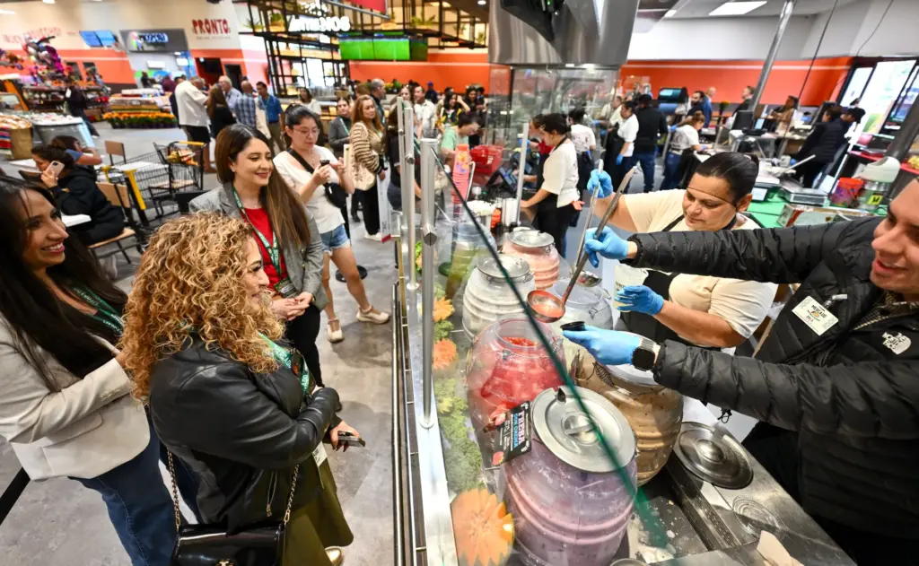 Employees serve up Aguas Frescas La Delicias during opening day...