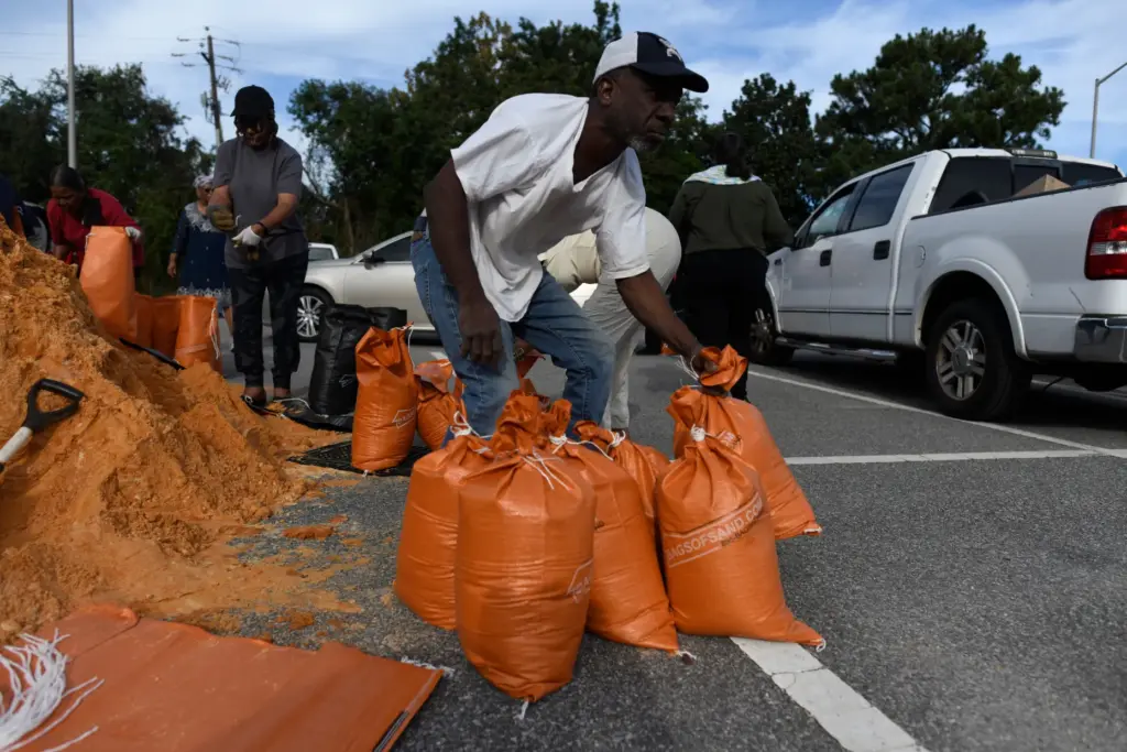 Residents pick up sandbags for storm preparation at the James...