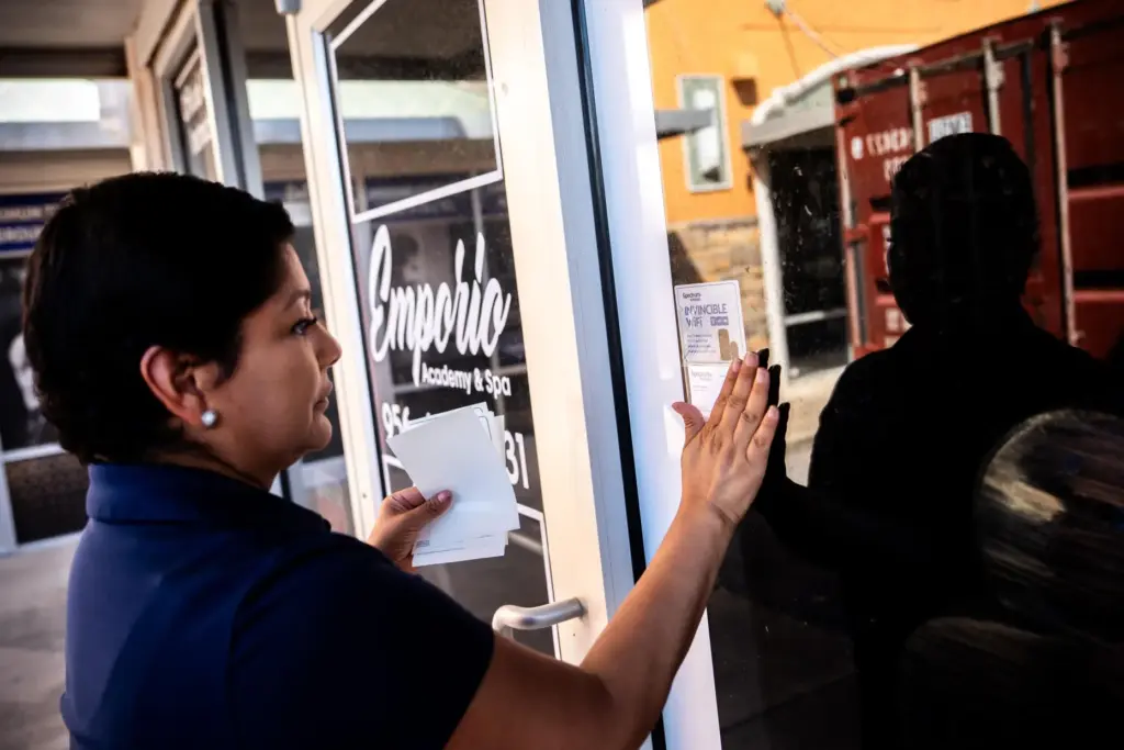 Cindy Banda leaves a flyer advertising Spectrum services near the...