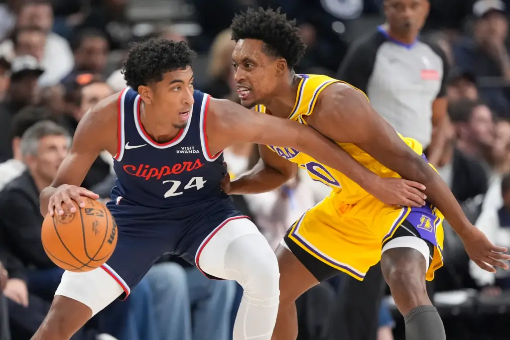 Clippers guard Cam Christie, left, tries to get past Lakers...