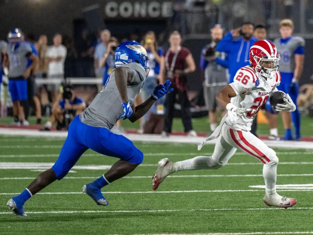 Mater Dei wide receiver Tristan Brown (26) carries the ball...
