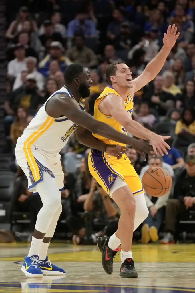 Golden State Warriors forward Draymond Green, left, fouls Lakers guard...