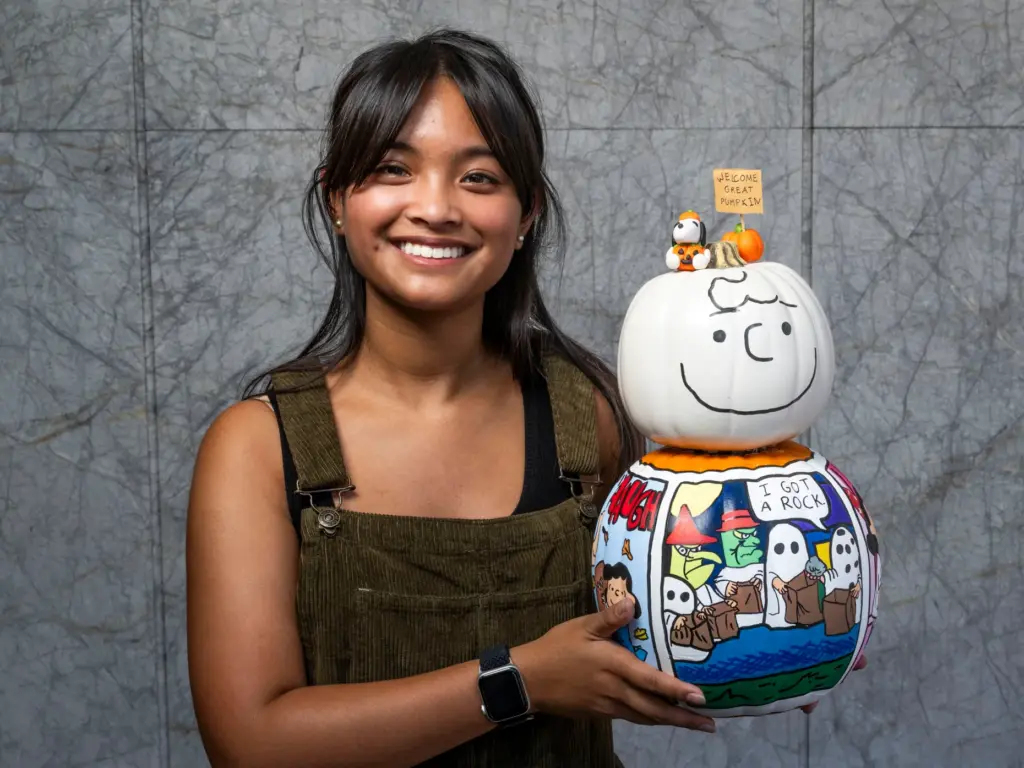 Ava Bayan holds her pumpkin titled âWelcome Great Pumpkin!â which...