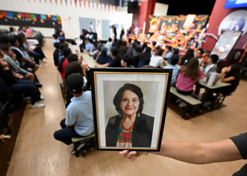 A staff member at Dolores Huerta International Academy holds a...