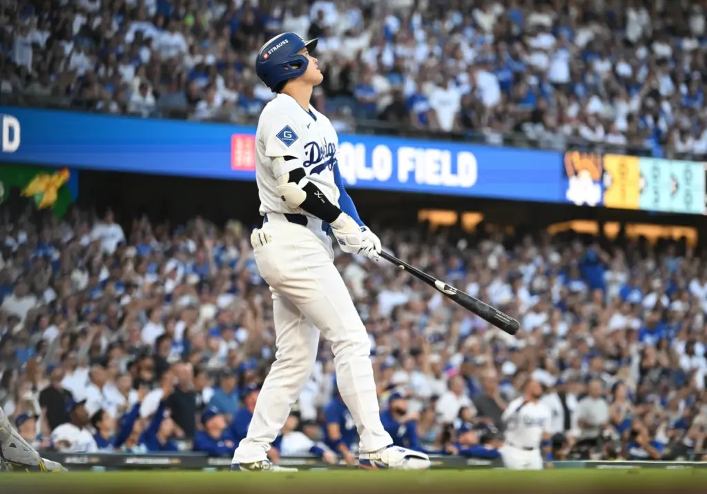 Dodgers star Shohei Ohtani watches the flight of his three-run...
